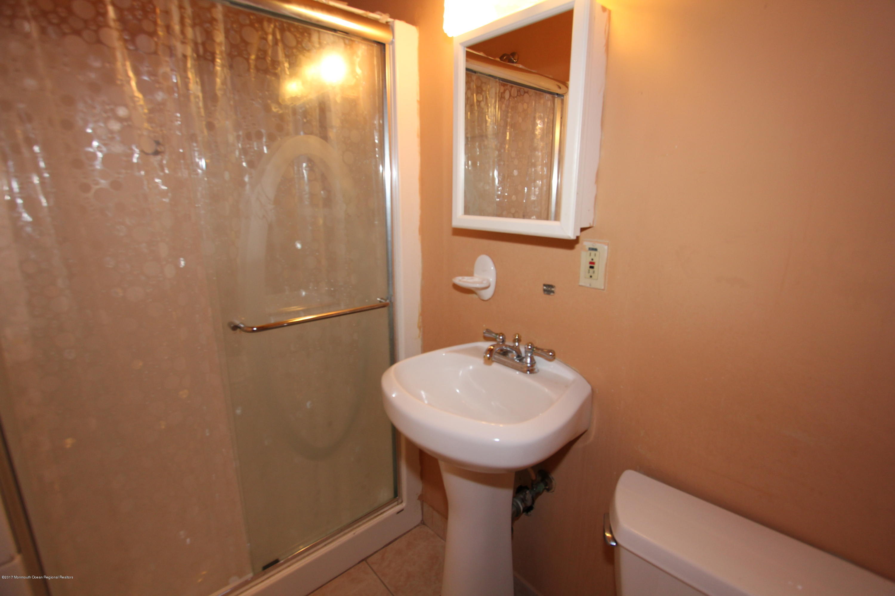 904 Fordham Road Neptune Township, NJ 07753 - Photo 17 of 24 a bathroom with a sink a toilet and mirror