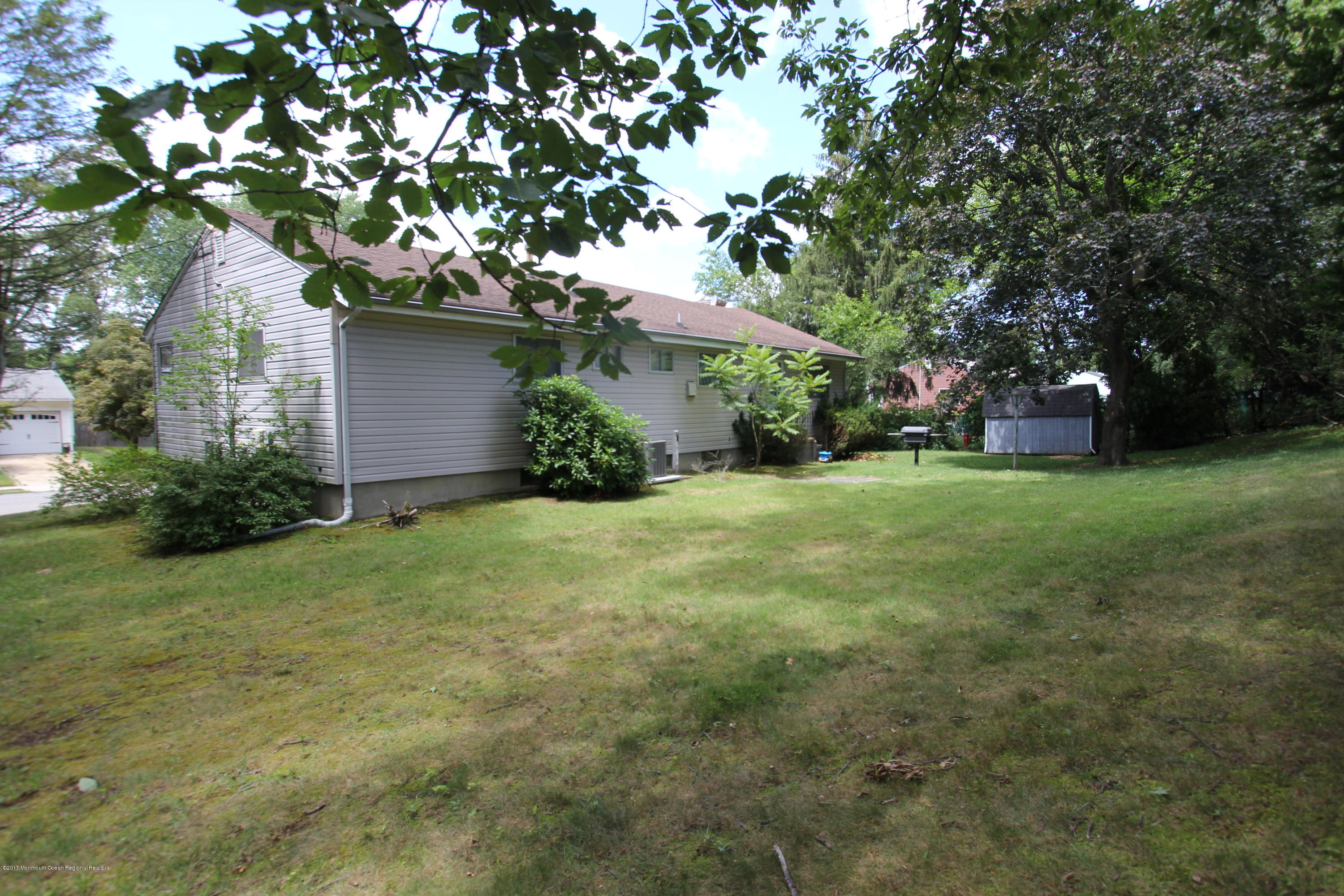 904 Fordham Road Neptune Township, NJ 07753 - Photo 19 of 24 a view of a tree in front of a house next to a yard
