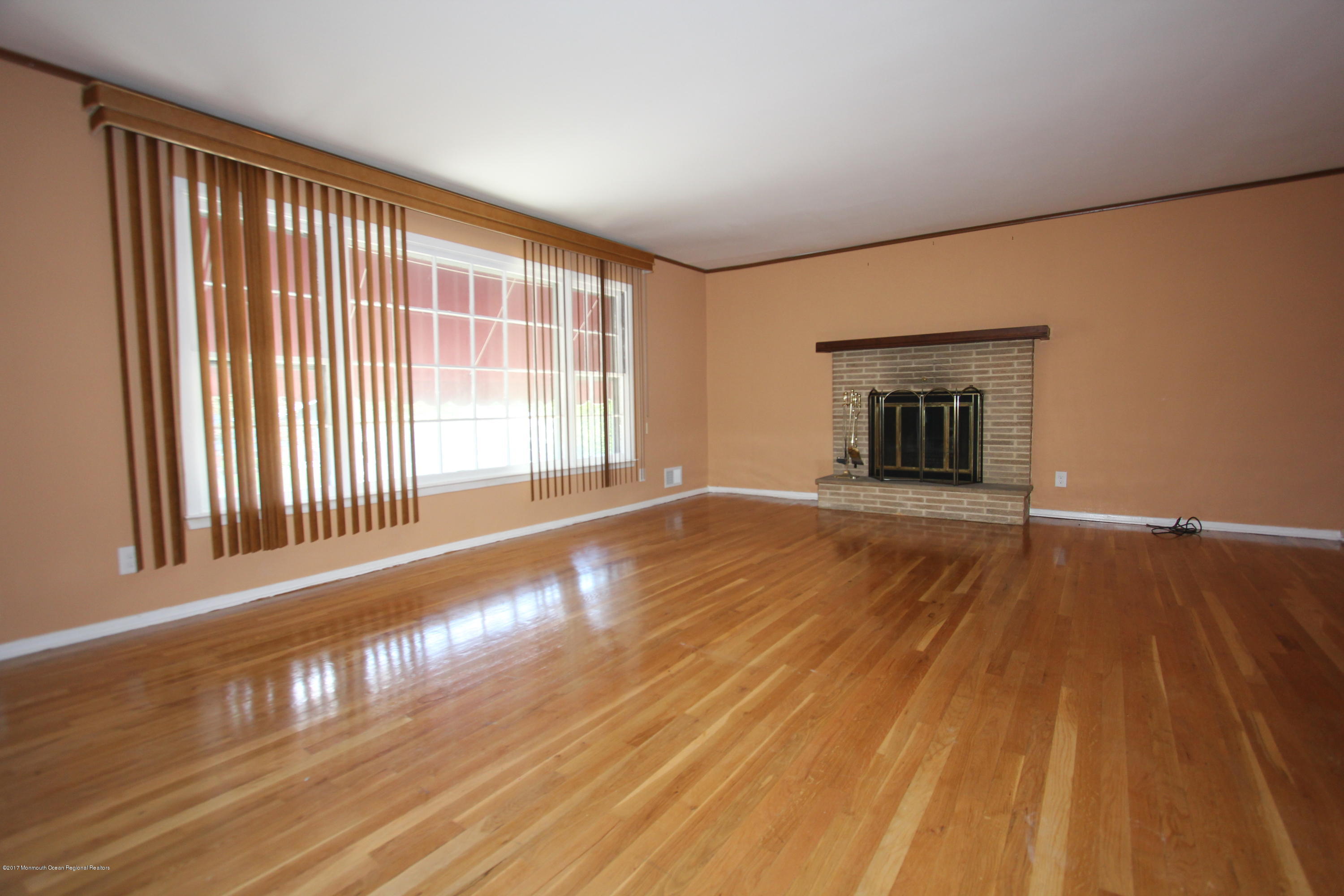904 Fordham Road Neptune Township, NJ 07753 - Photo 3 of 24 a view of an empty room with wooden floor and a window