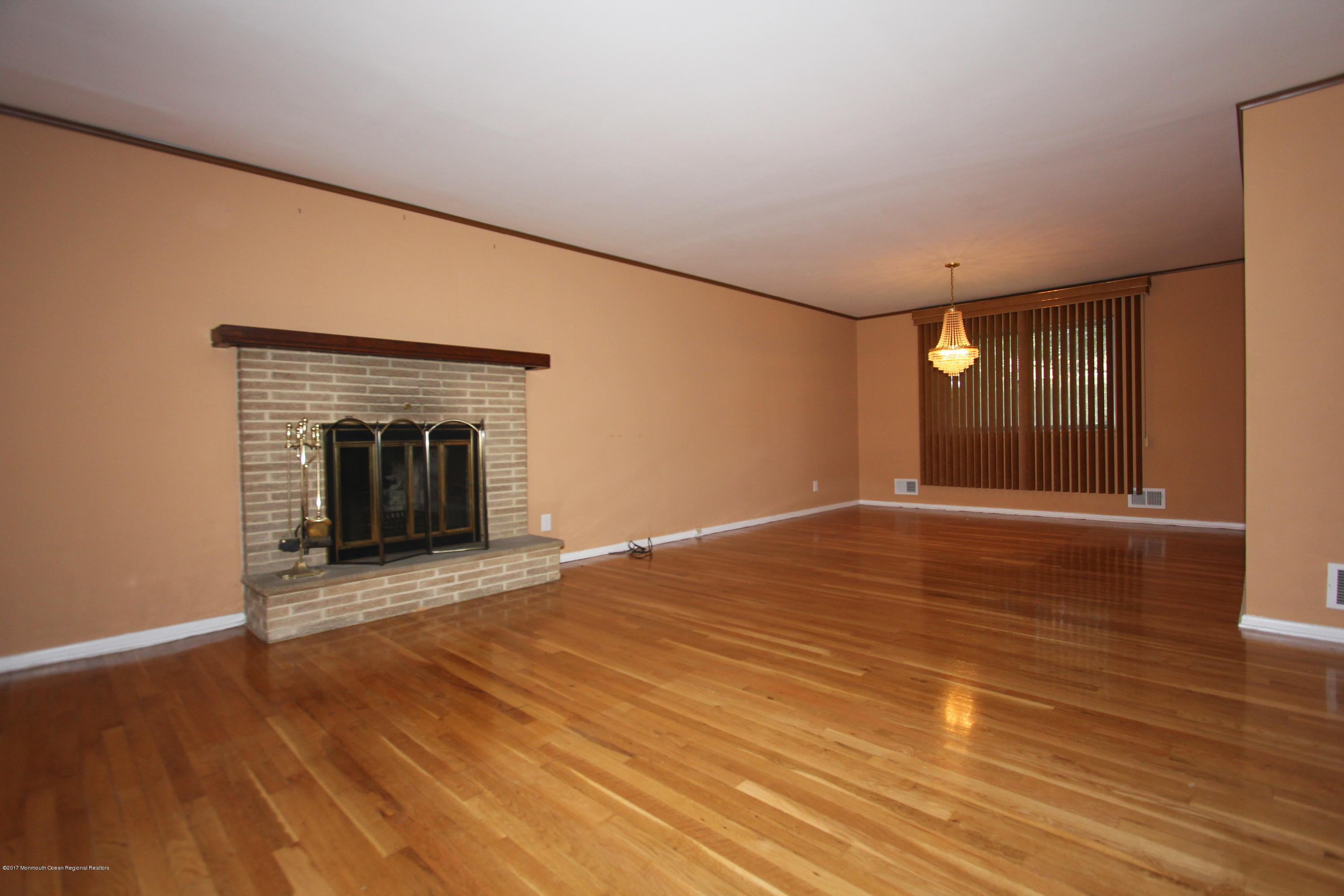 904 Fordham Road Neptune Township, NJ 07753 - Photo 4 of 24 a view of empty room with wooden floor and fireplace