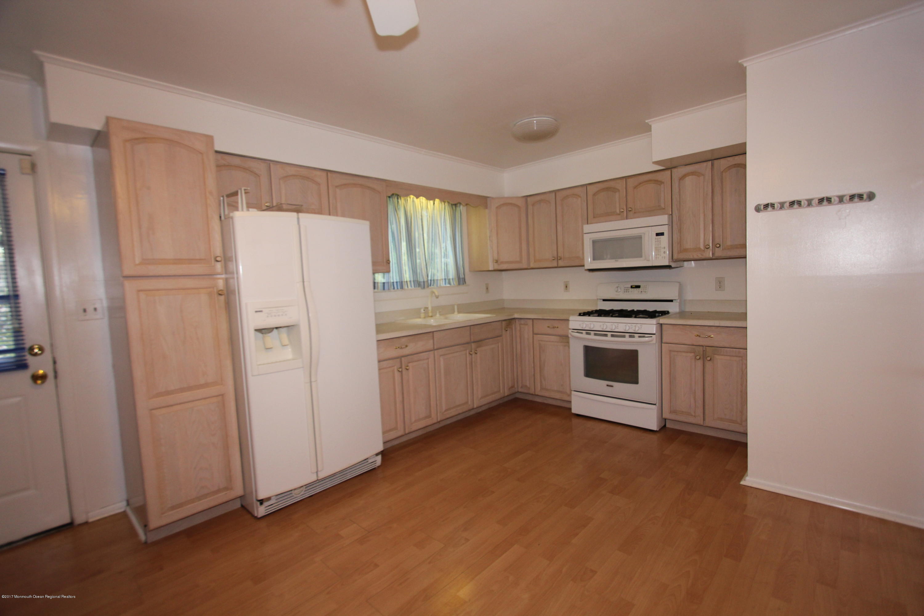 904 Fordham Road Neptune Township, NJ 07753 - Photo 5 of 24 a kitchen with white cabinets and white appliances