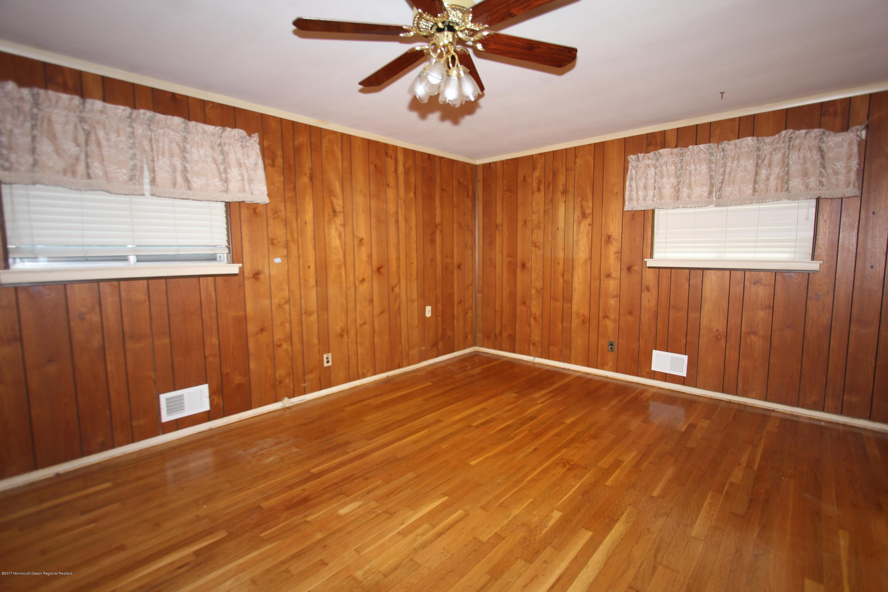 904 Fordham Road Neptune Township, NJ 07753 - Photo 9 of 24 a view of an empty room with window and wooden floor