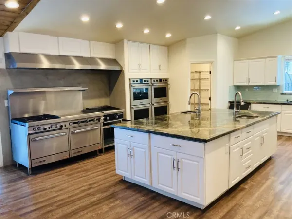 a stove top oven sitting inside of a kitchen