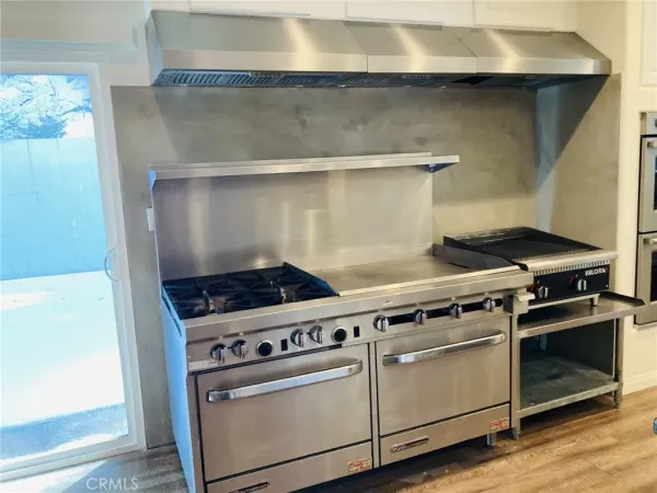 a kitchen with granite countertop white cabinets and sink