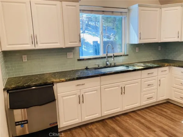 a stove top oven sitting inside of a kitchen