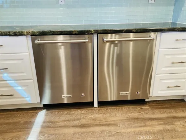 a kitchen with granite countertop a stove and a microwave