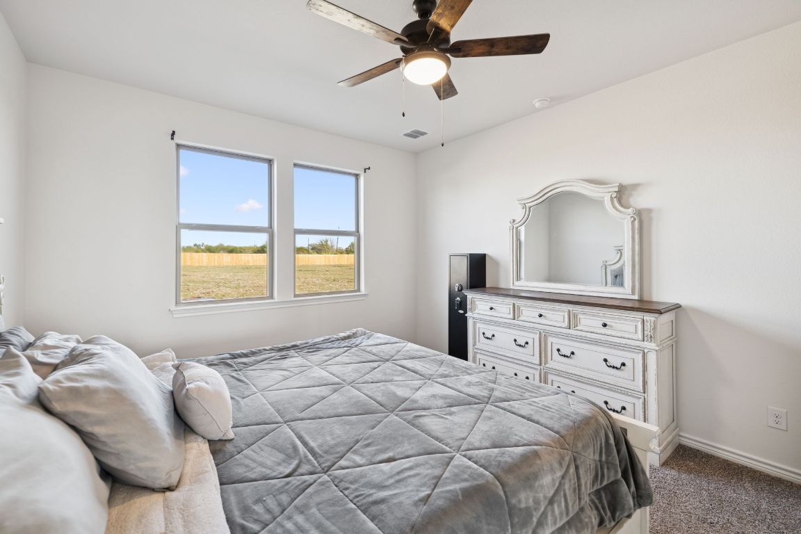 108 Santa Teresa Road Kyle, TX 78640 - Photo 11 of 26 a bedroom with a bed and a window