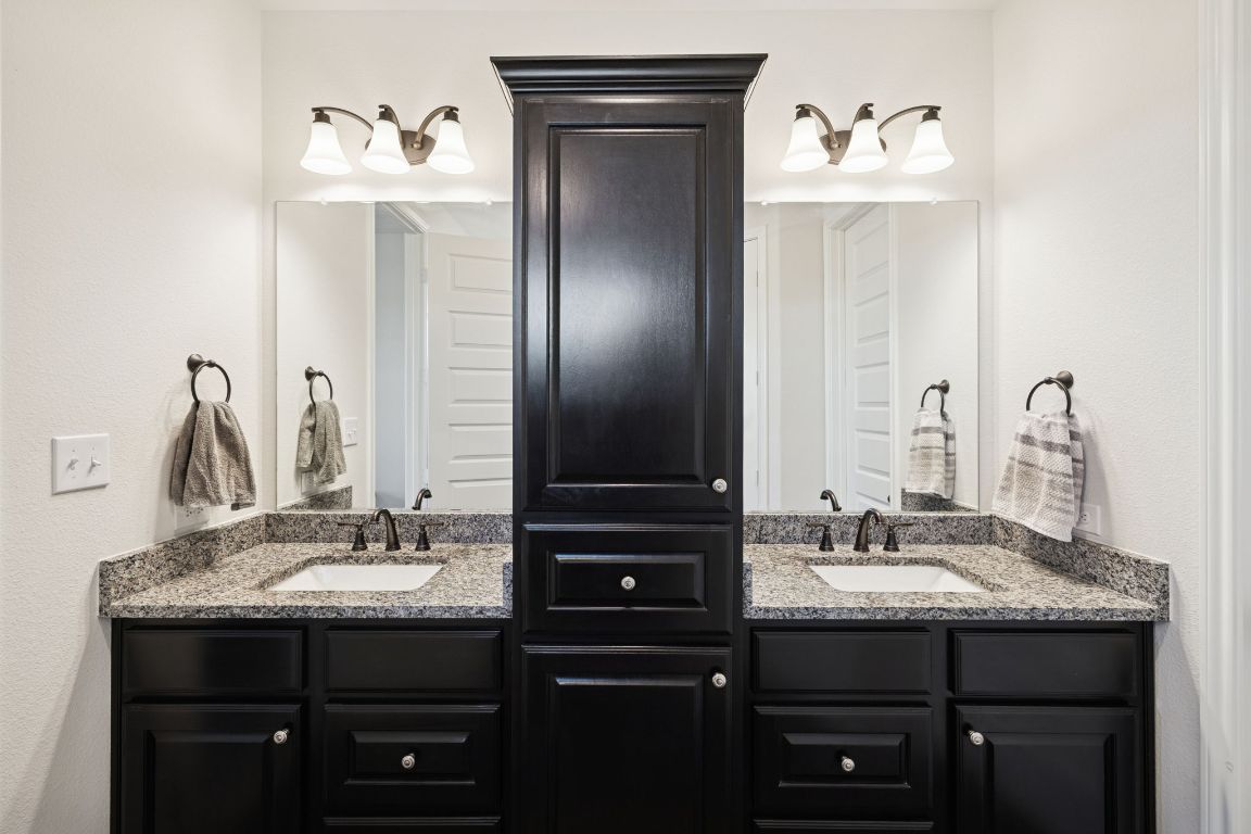 108 Santa Teresa Road Kyle, TX 78640 - Photo 13 of 26 a bathroom with a sink and a mirror