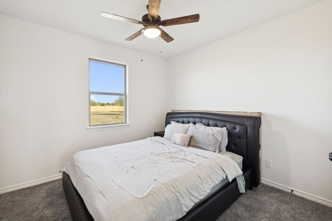108 Santa Teresa Road Kyle, TX 78640 - Photo 16 of 26 a bedroom with a bed and a window
