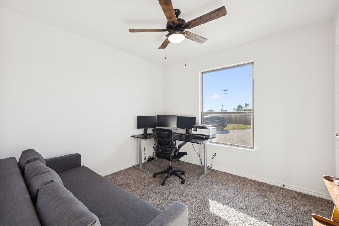 108 Santa Teresa Road Kyle, TX 78640 - Photo 19 of 26 a workspace with furniture and a window