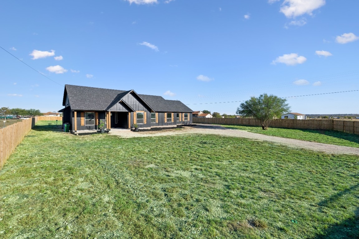 108 Santa Teresa Road Kyle, TX 78640 - Photo 25 of 26 a view of a house with a yard and sitting area