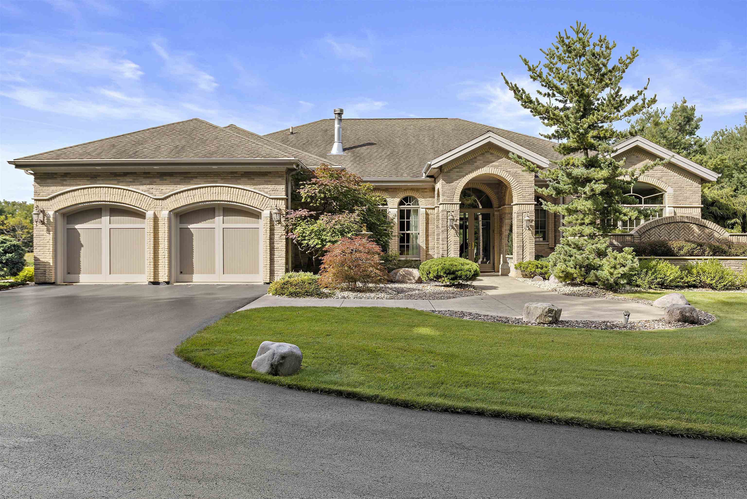 a front view of a house with a garden