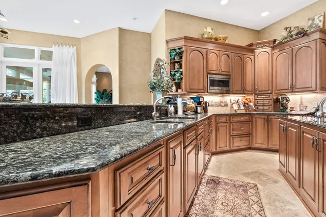 a dining room with furniture a chandelier and wooden floor