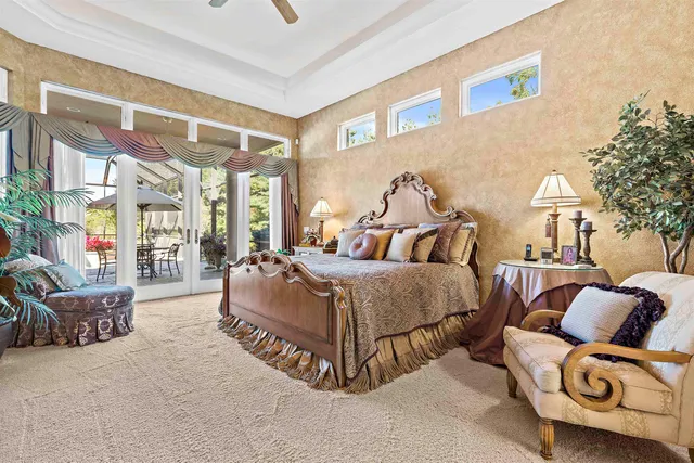 a walk in closet with clothes and shoes