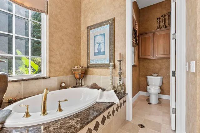 a large white kitchen with a large window