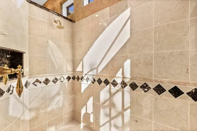 a view of a patio with a table and chairs under an umbrella