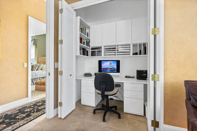 a view of the patio with a table and chairs under an umbrella