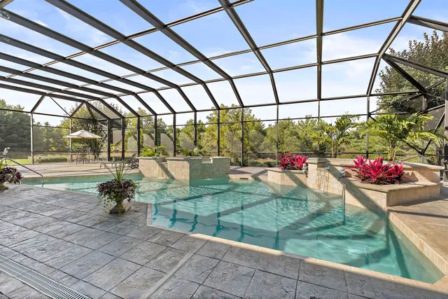 an aerial view of a house with a yard and large trees
