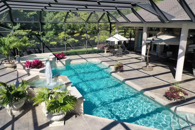 a view of a swimming pool with a yard