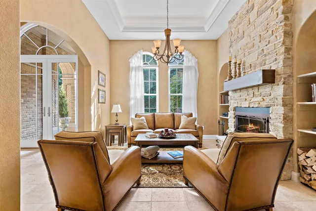 a living room with furniture fireplace and a large window