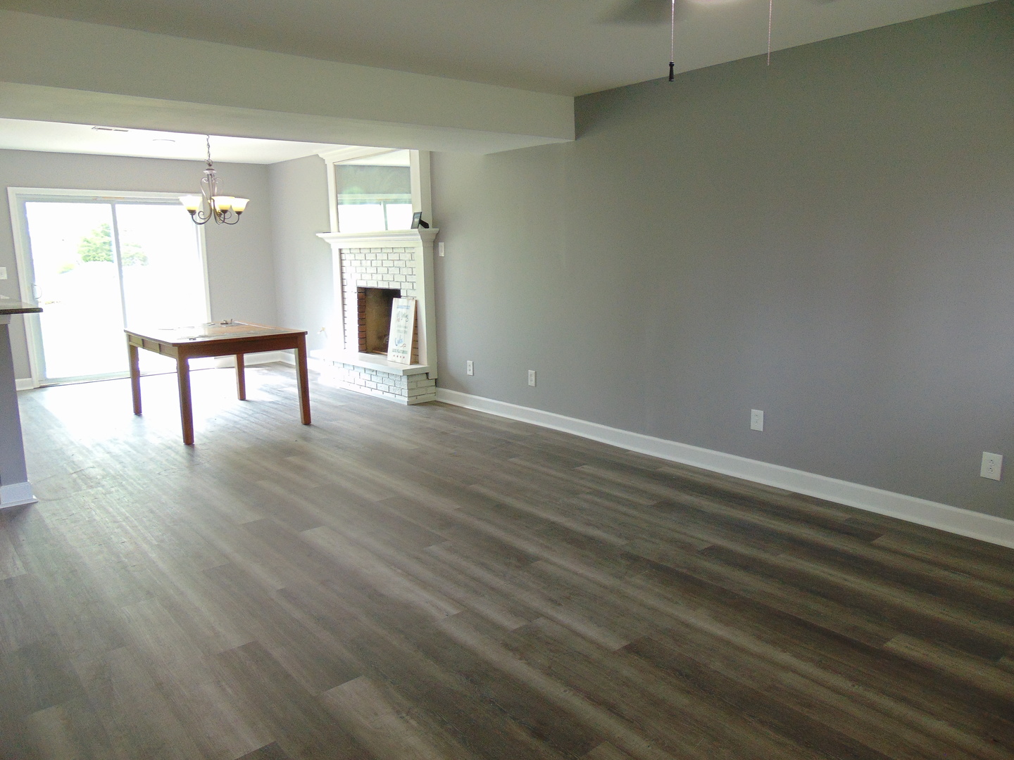 307 North Raven Road Shorewood, IL 60404 - Photo 8 of 22 a view of an empty room with wooden floor and a window