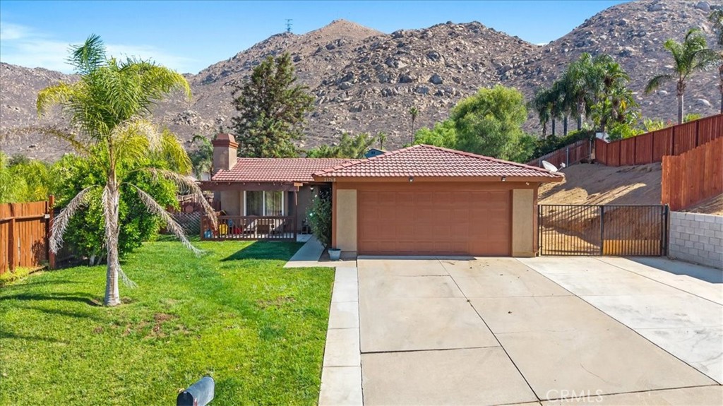 21768 Winding Road Moreno Valley, CA 92557 - Photo 1 of 1 a front view of a house with a yard and garage