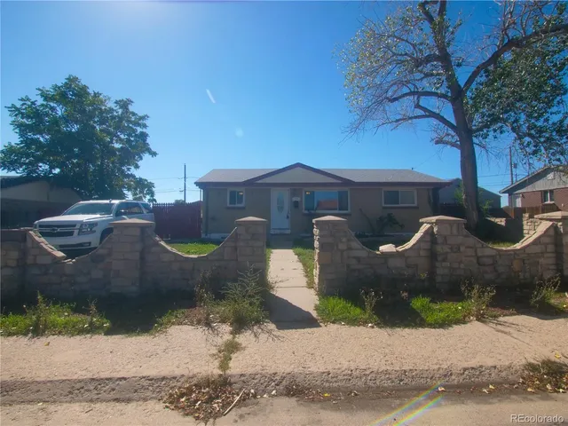 a front view of a house with a yard and a garage