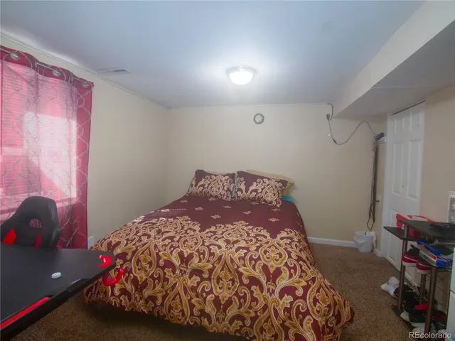 a bedroom with a bed and a dresser