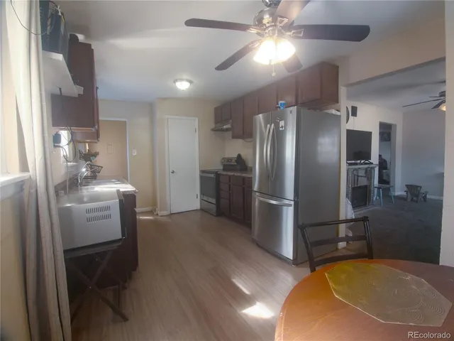 a kitchen with refrigerator a sink and cabinets