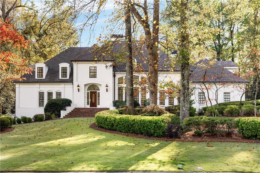 3478 Valley Road Northwest Atlanta, GA 30305 - Photo 1 of 1 a front view of a house with a yard garage and outdoor seating