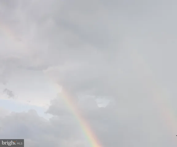 a view of bathroom with a sink and mirror