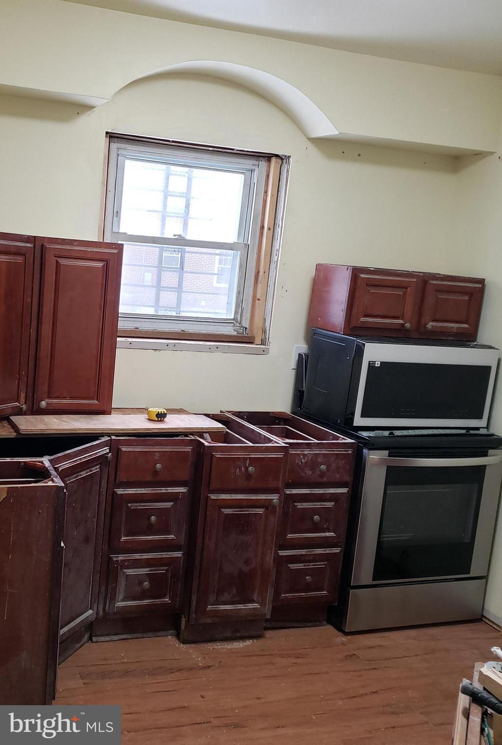 4116 Garrison Boulevard Baltimore, MD 21215 - Photo 16 of 23 a room with furniture and wooden floor