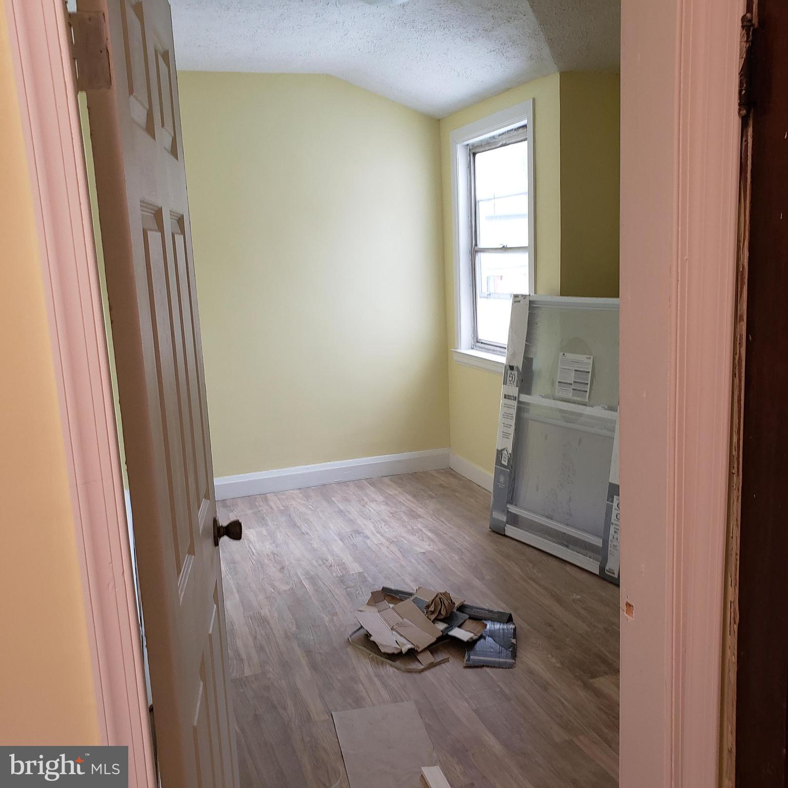 4116 Garrison Boulevard Baltimore, MD 21215 - Photo 19 of 23 a room with wooden floor and shoes