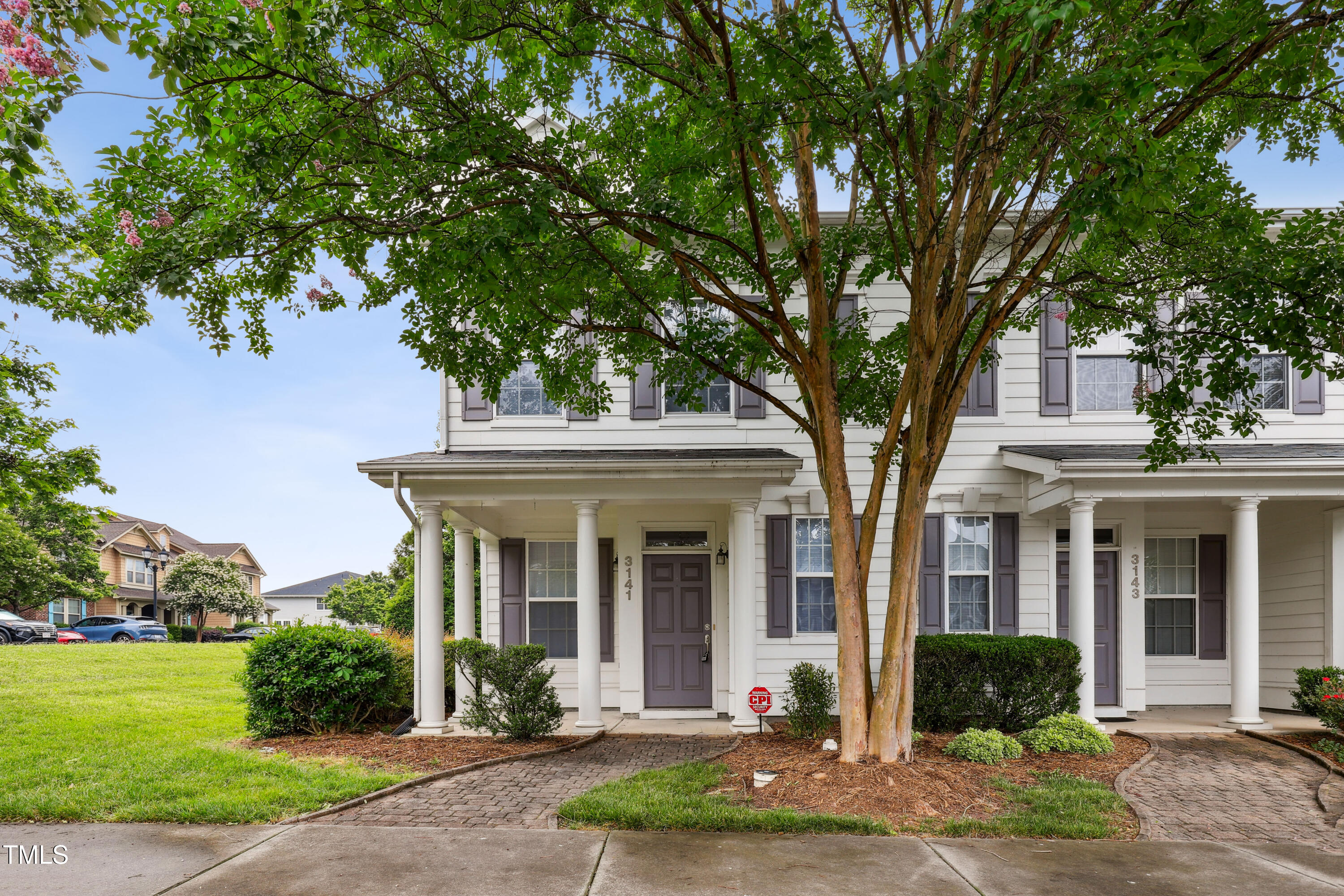 front view of a brick house with a yard