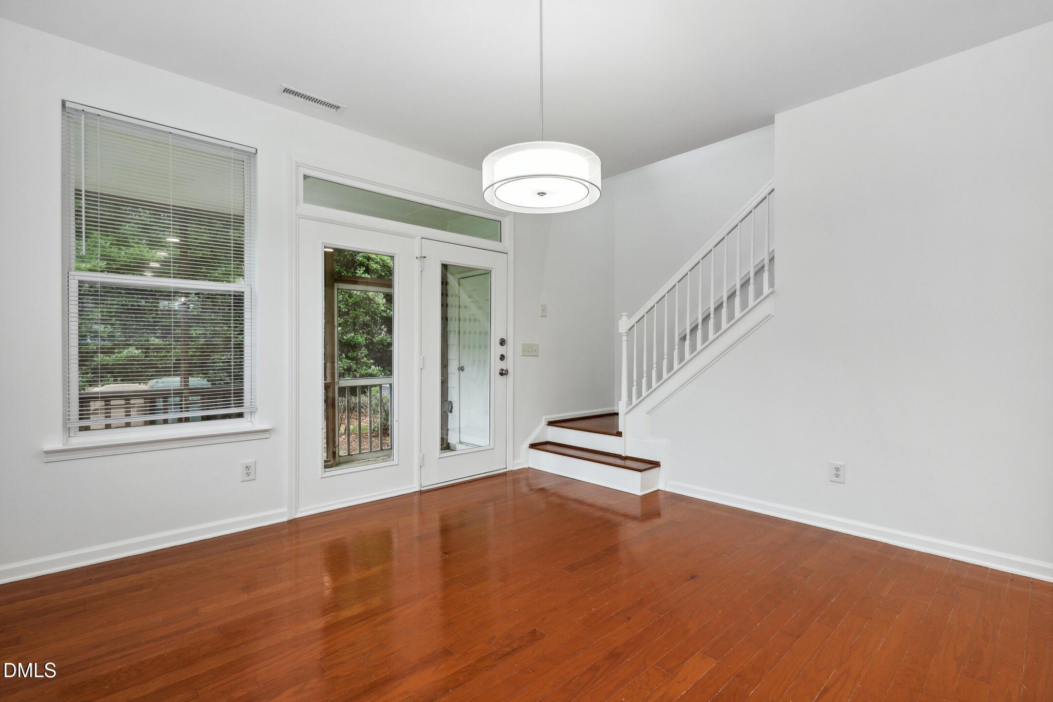 3141 Rapid Falls Road Cary, NC 27519 - Photo 11 of 28 a view of an empty room with wooden floor and a window