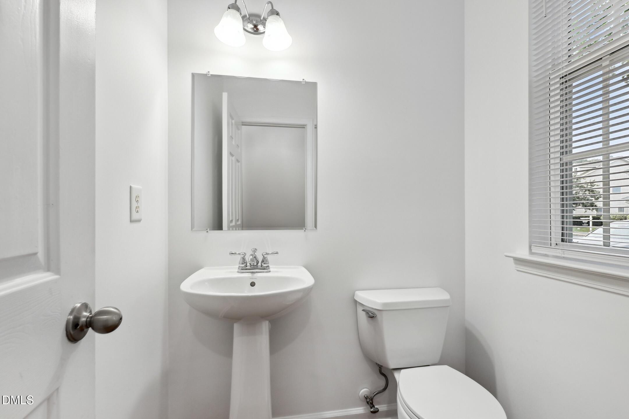 3141 Rapid Falls Road Cary, NC 27519 - Photo 14 of 28 a bathroom with a sink a toilet and mirror