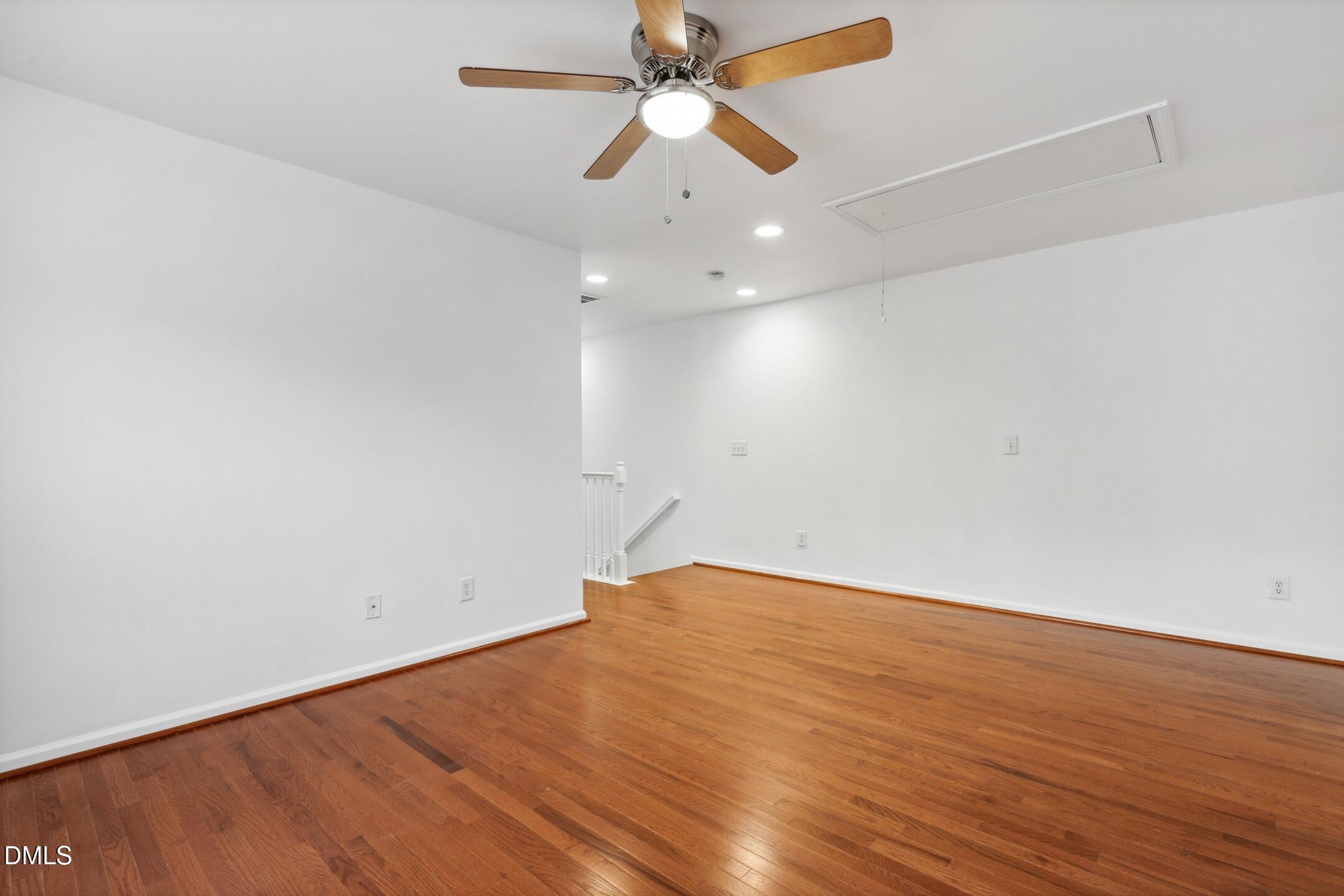 3141 Rapid Falls Road Cary, NC 27519 - Photo 16 of 28 an empty room with wooden floor fan and ceiling fan
