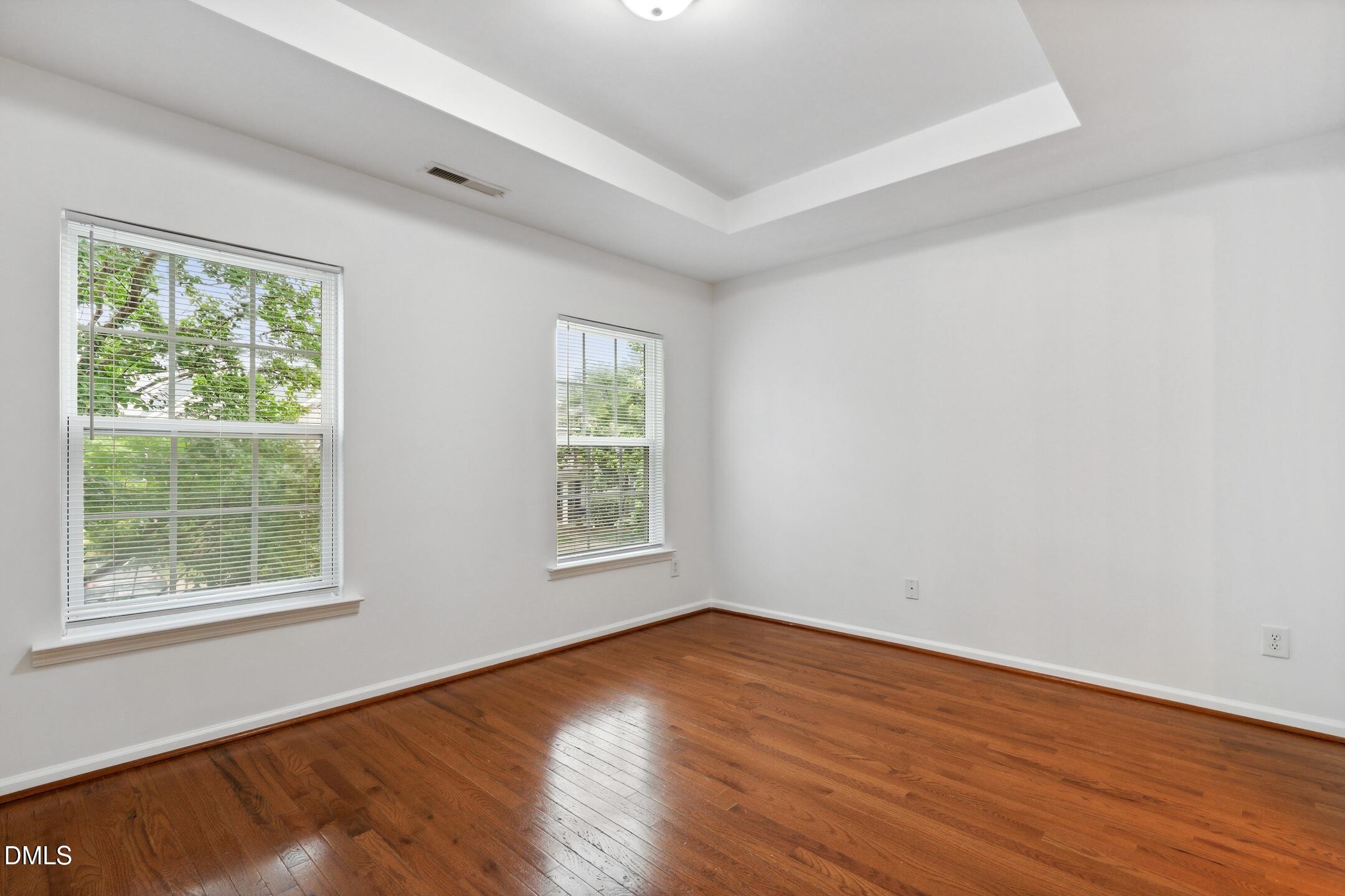 3141 Rapid Falls Road Cary, NC 27519 - Photo 17 of 28 an empty room with wooden floor and windows