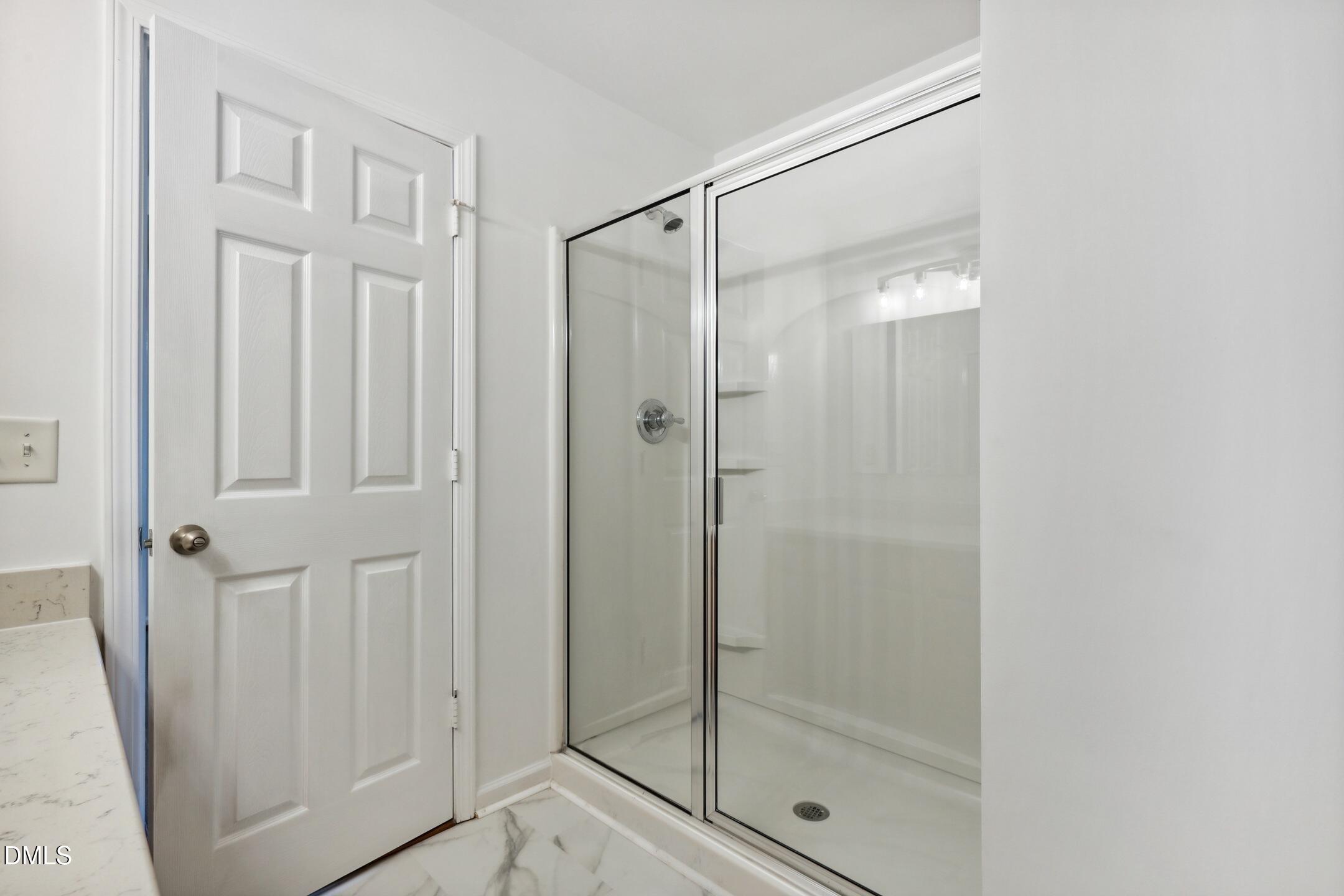 3141 Rapid Falls Road Cary, NC 27519 - Photo 21 of 28 a bathroom with a glass shower door