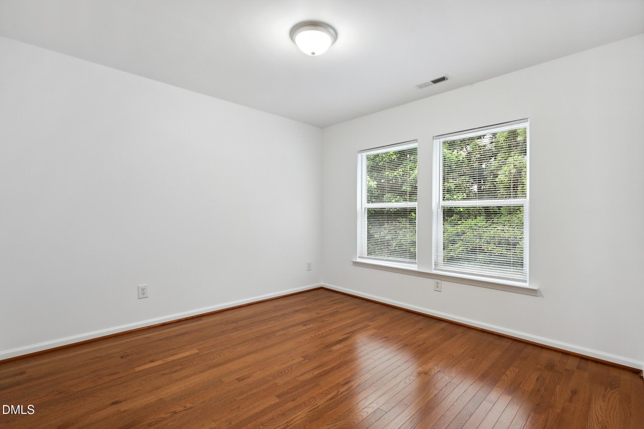 3141 Rapid Falls Road Cary, NC 27519 - Photo 22 of 28 an empty room with wooden floor and windows