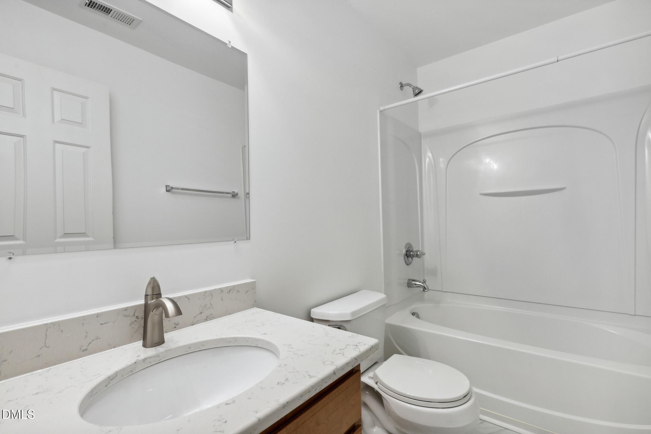 3141 Rapid Falls Road Cary, NC 27519 - Photo 24 of 28 a bathroom with a granite countertop sink toilet and shower