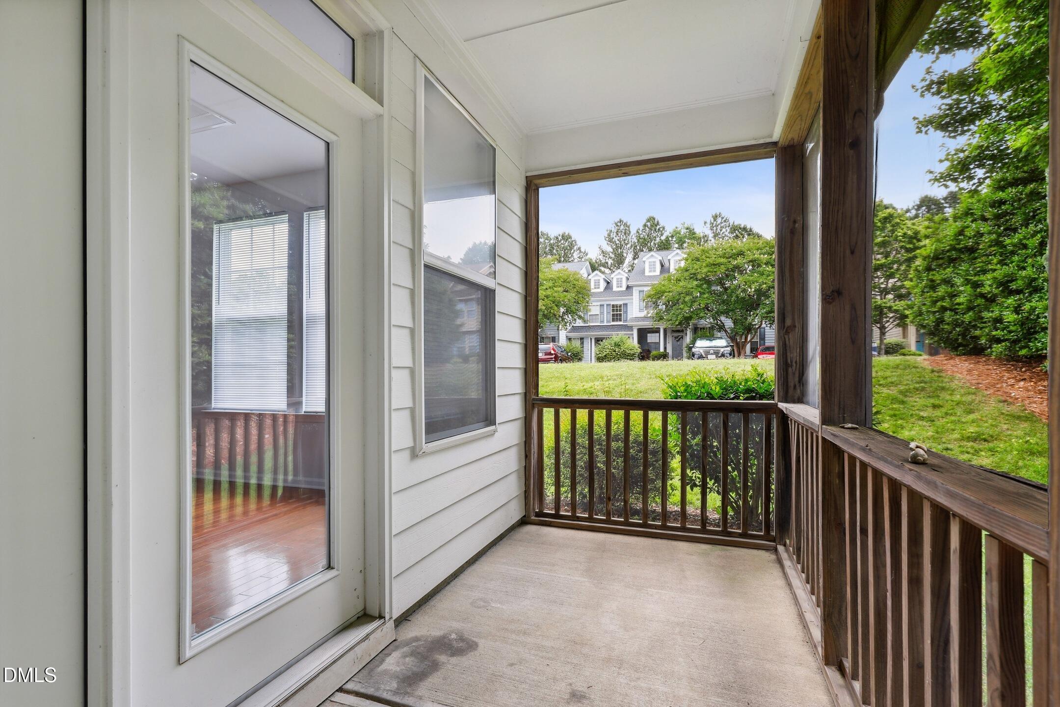 3141 Rapid Falls Road Cary, NC 27519 - Photo 27 of 28 a view of a porch with a floor to ceiling window and wooden floor