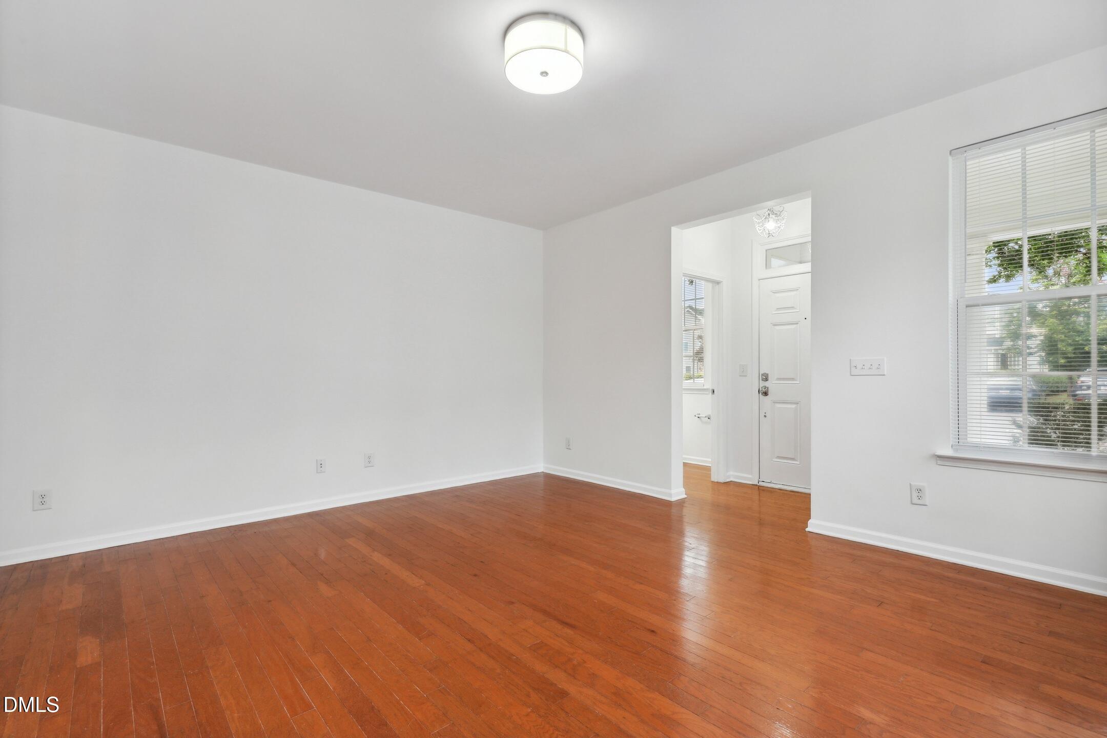 3141 Rapid Falls Road Cary, NC 27519 - Photo 4 of 28 an empty room with wooden floor and windows
