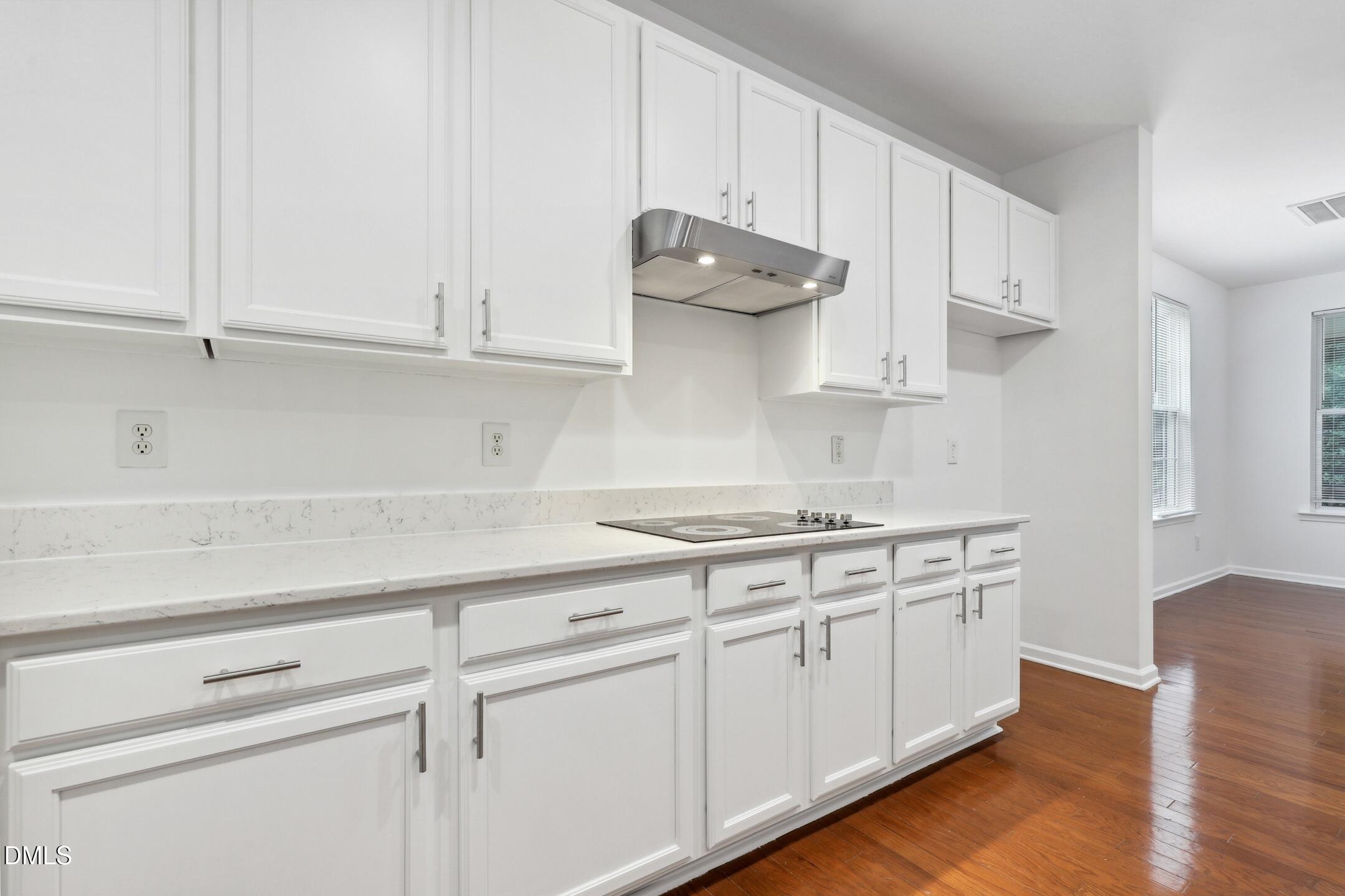 3141 Rapid Falls Road Cary, NC 27519 - Photo 9 of 28 a kitchen with white cabinets and a stove