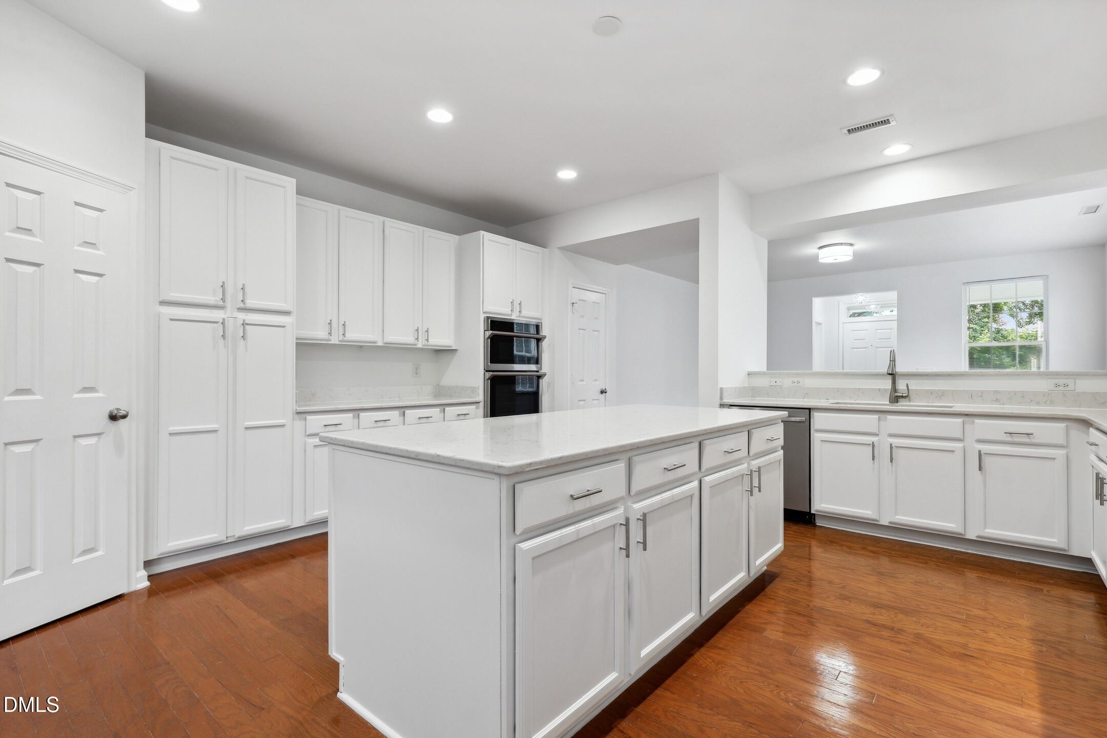 3141 Rapid Falls Road Cary, NC 27519 - Photo 10 of 28 a kitchen with white cabinets appliances a sink and a window