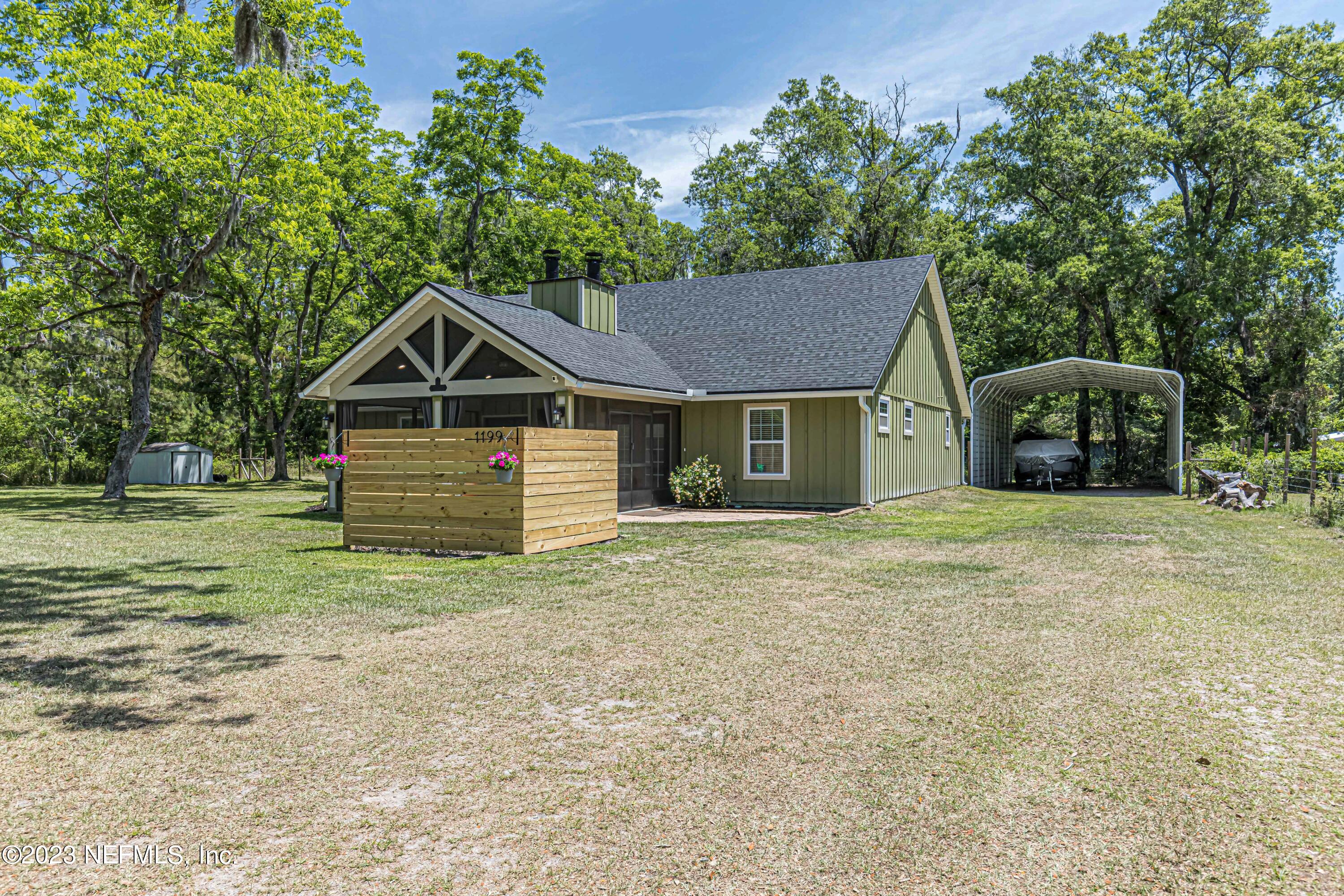 1199 Hatcher Road Middleburg, FL 32068 - Photo 19 of 55 a house with trees in the background