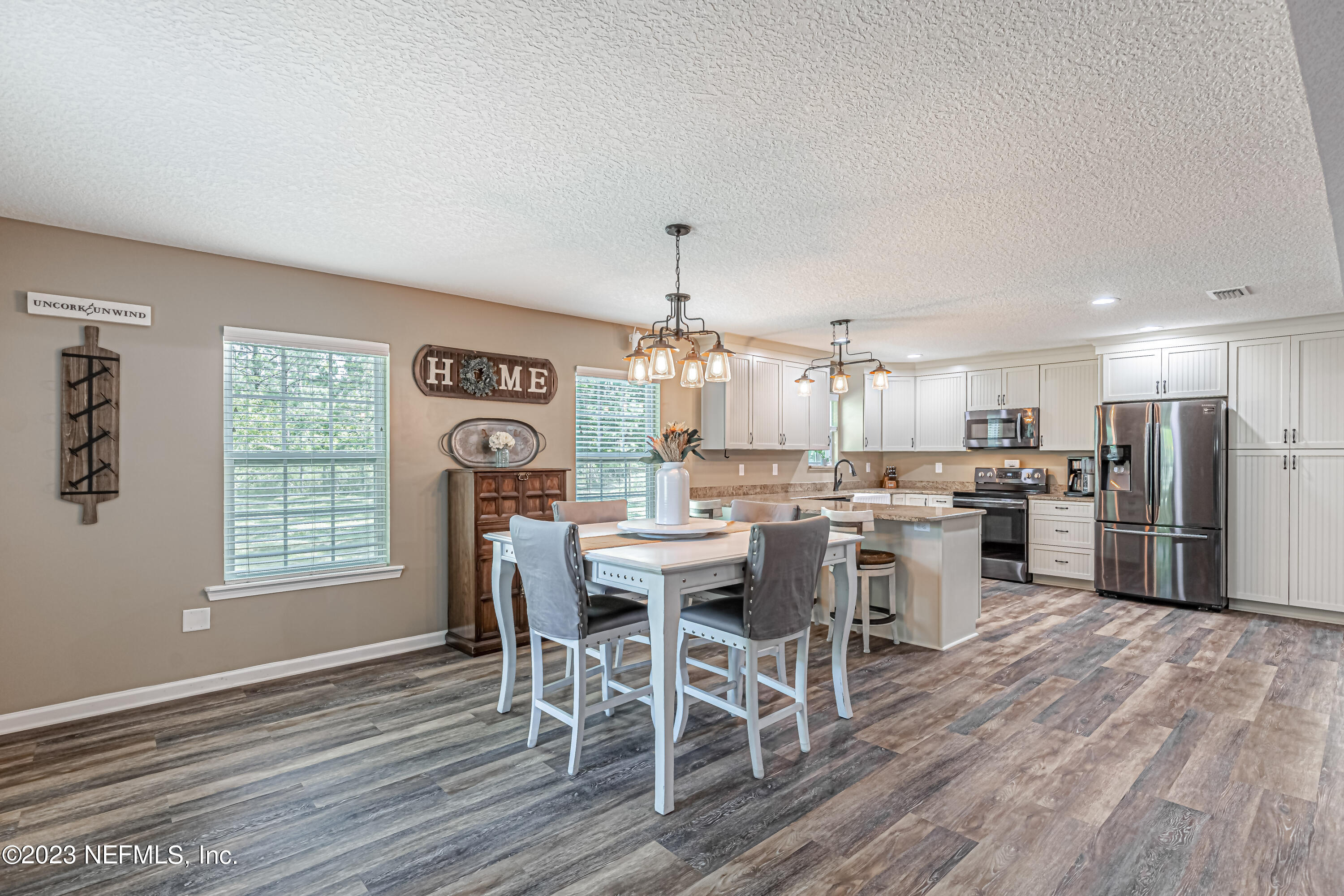 1199 Hatcher Road Middleburg, FL 32068 - Photo 24 of 55 a view of a dining room with furniture window and wooden floor