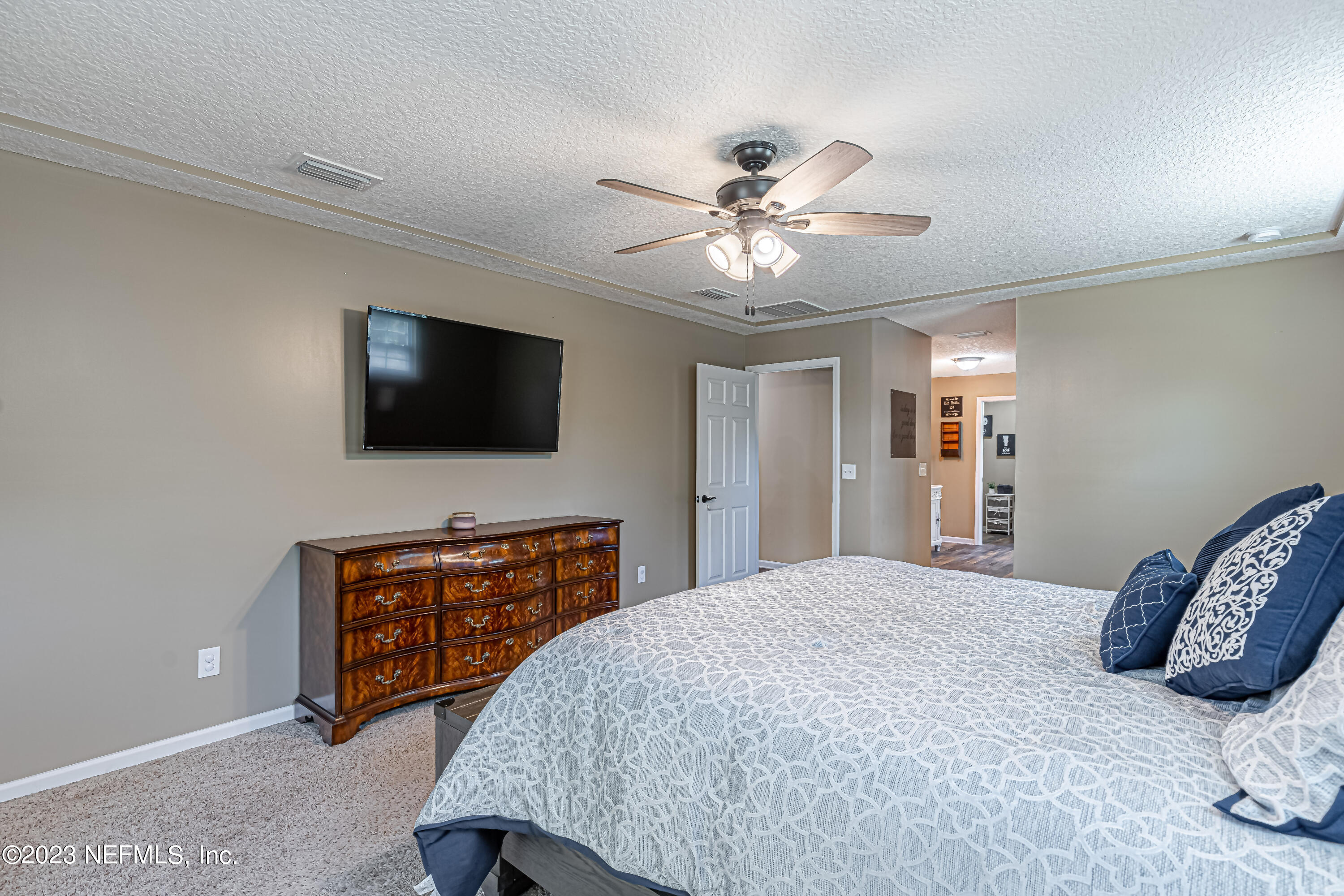 1199 Hatcher Road Middleburg, FL 32068 - Photo 30 of 55 a bedroom with a bed and a flat screen tv