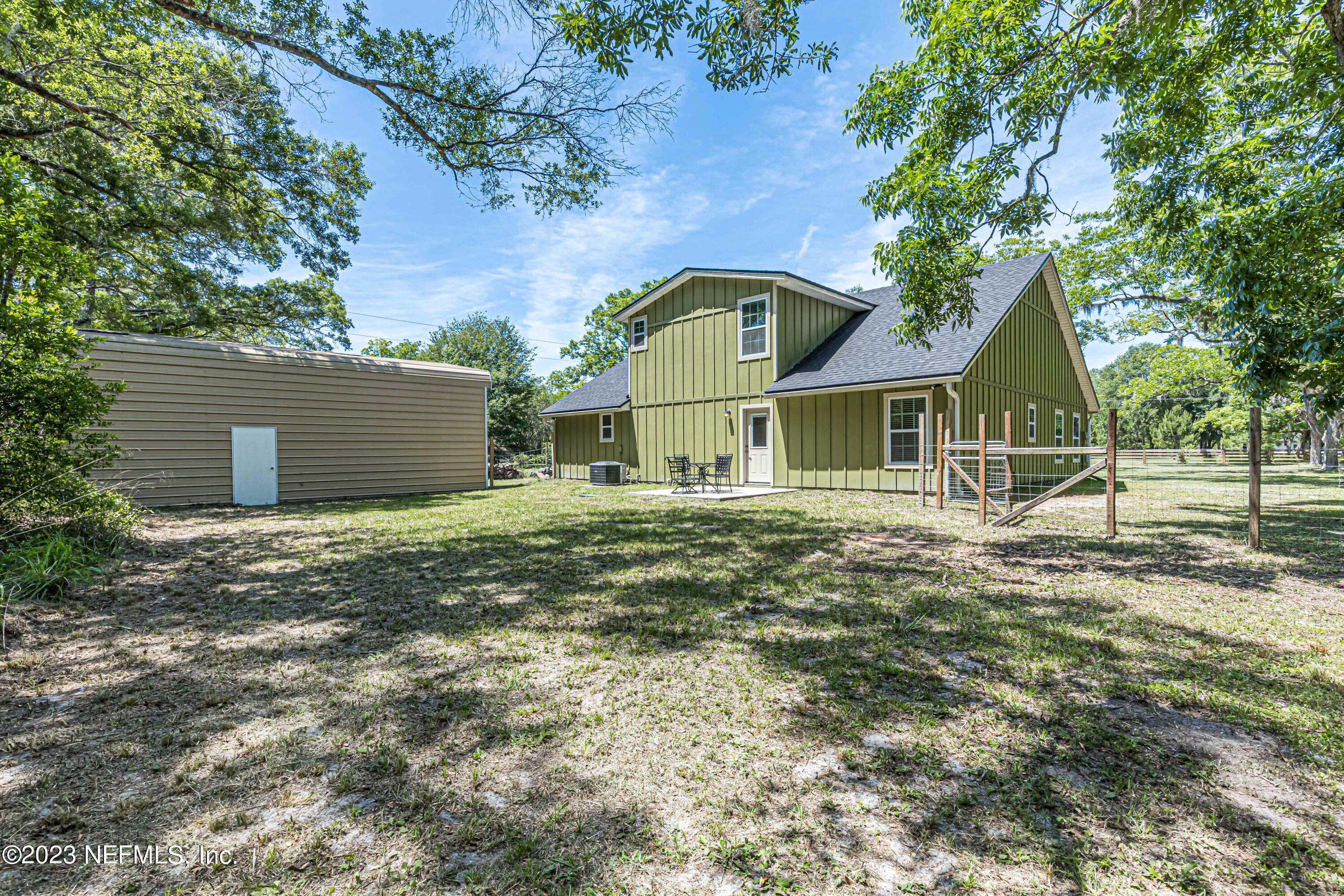 1199 Hatcher Road Middleburg, FL 32068 - Photo 46 of 55 a backyard of a house with table and chairs