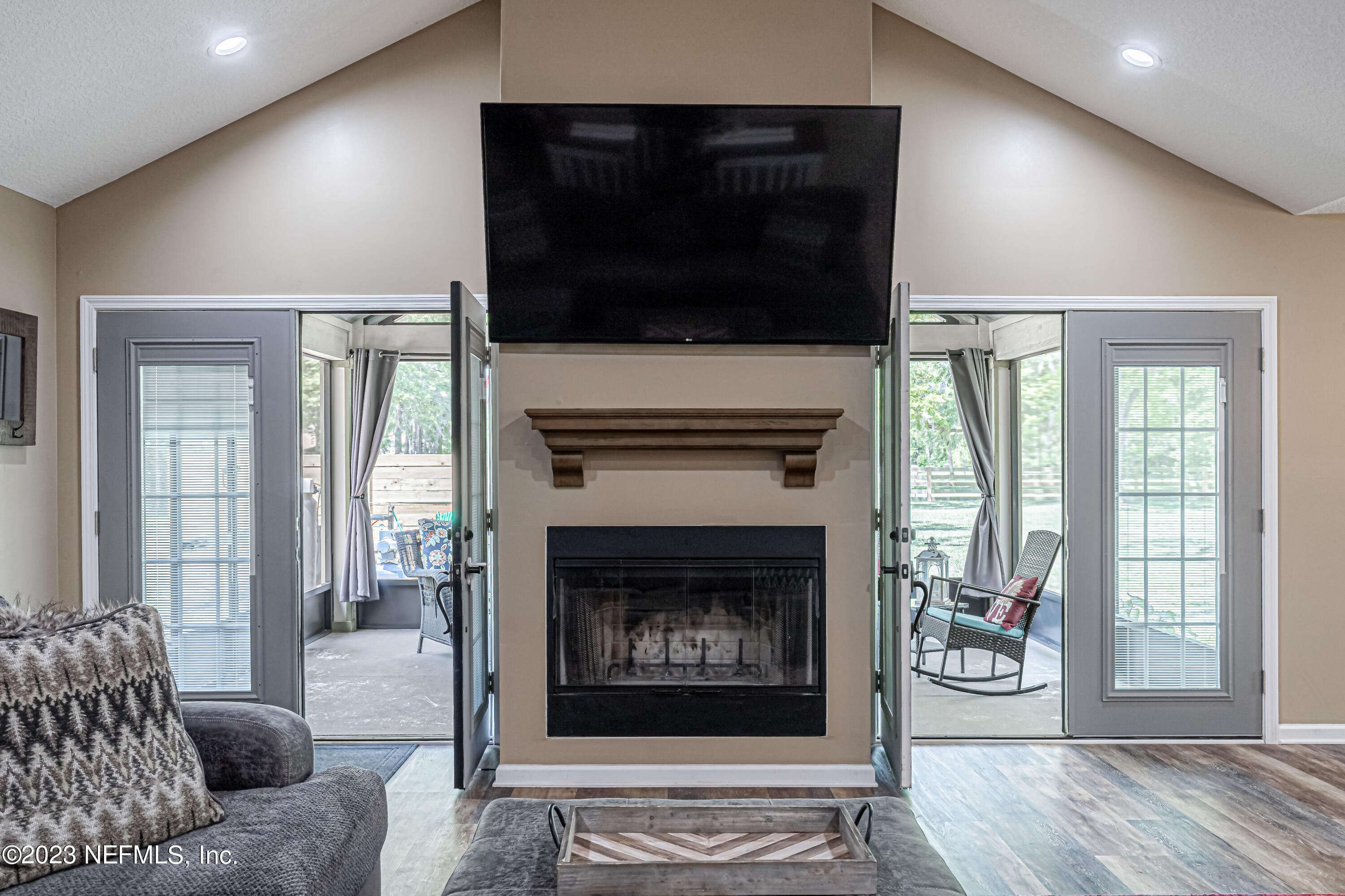 1199 Hatcher Road Middleburg, FL 32068 - Photo 5 of 55 a living room with furniture a flat screen tv and a fireplace